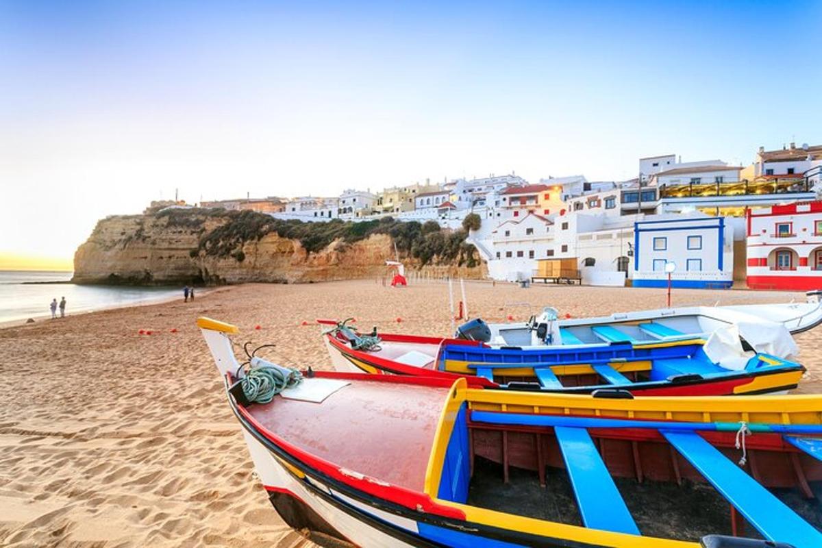 a group of boats sitting on a sandy beach