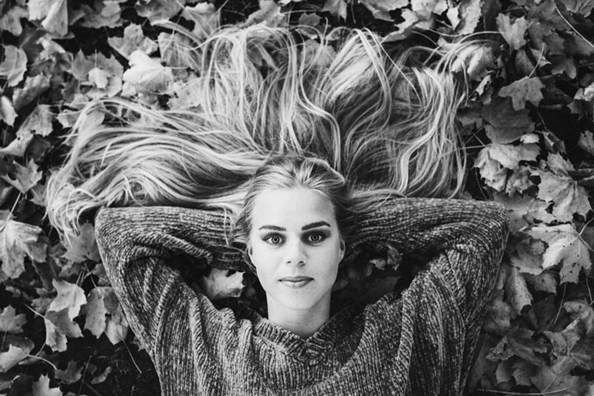 a woman laying on the ground with a pile of hair