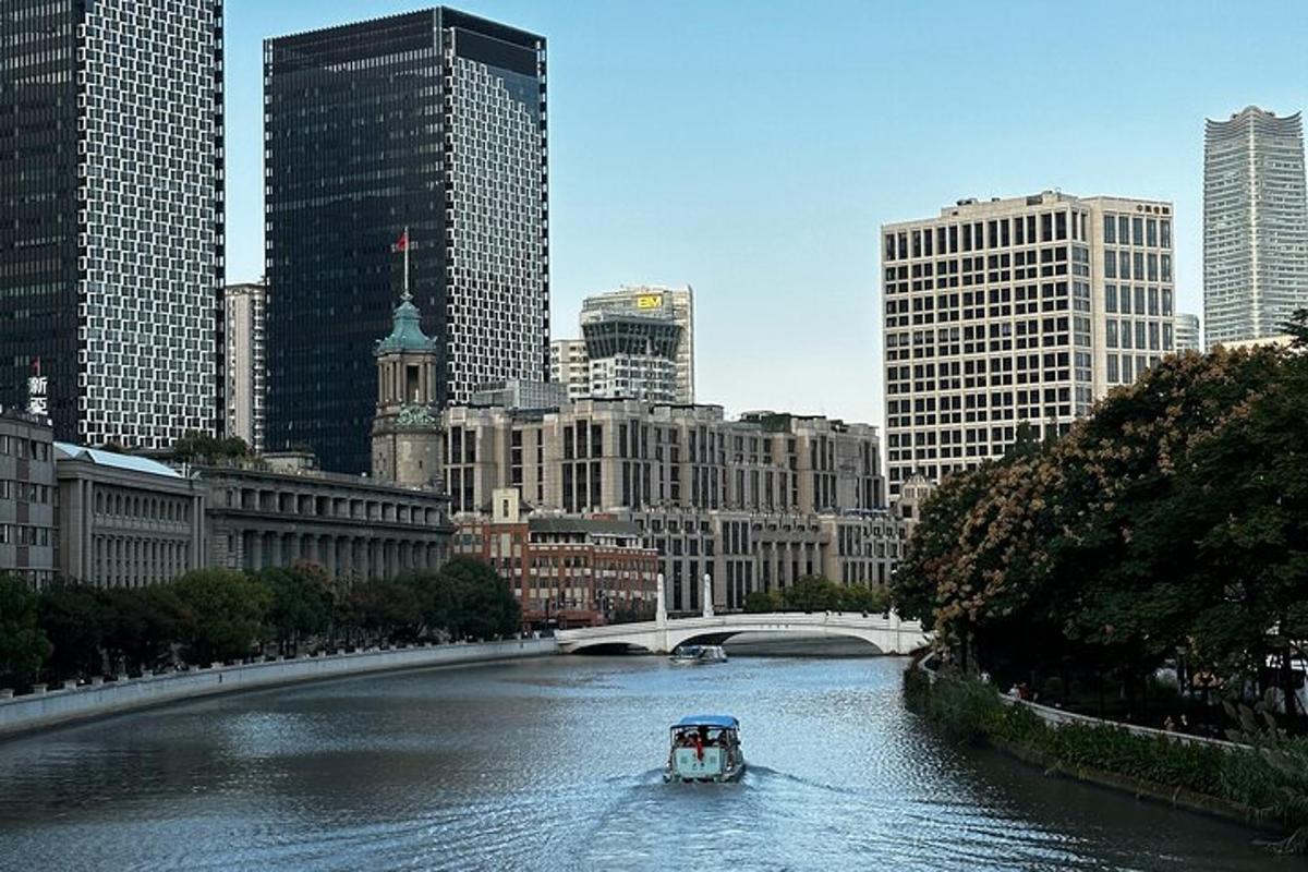 a boat traveling down a river in a city