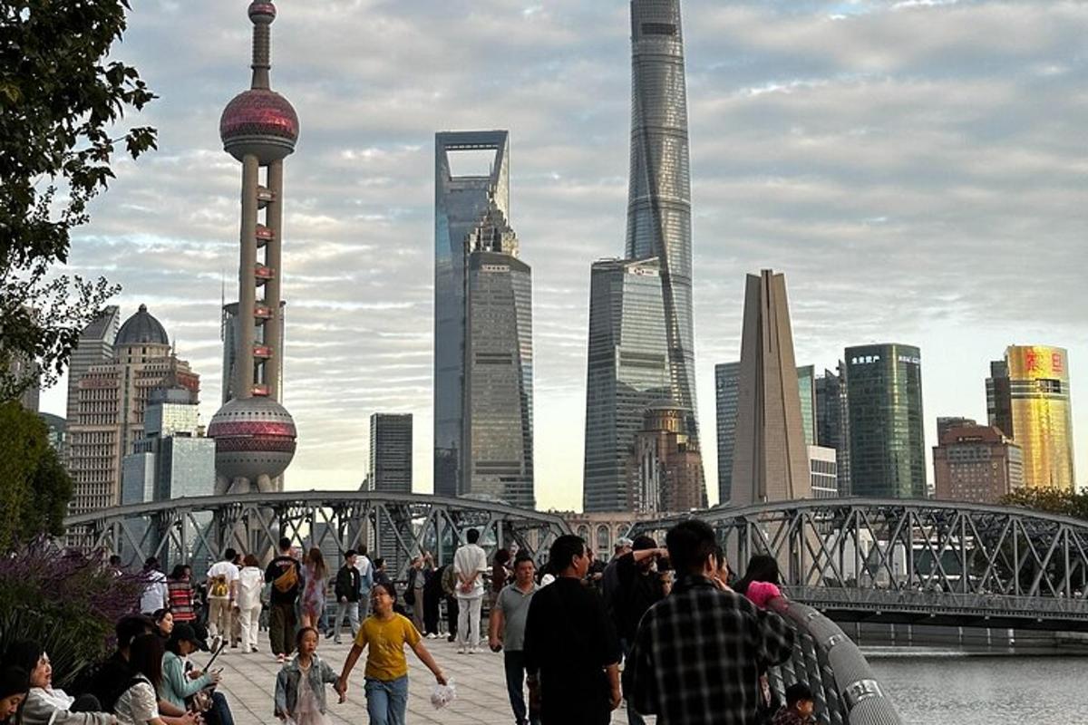 a group of people walking across a bridge in a city