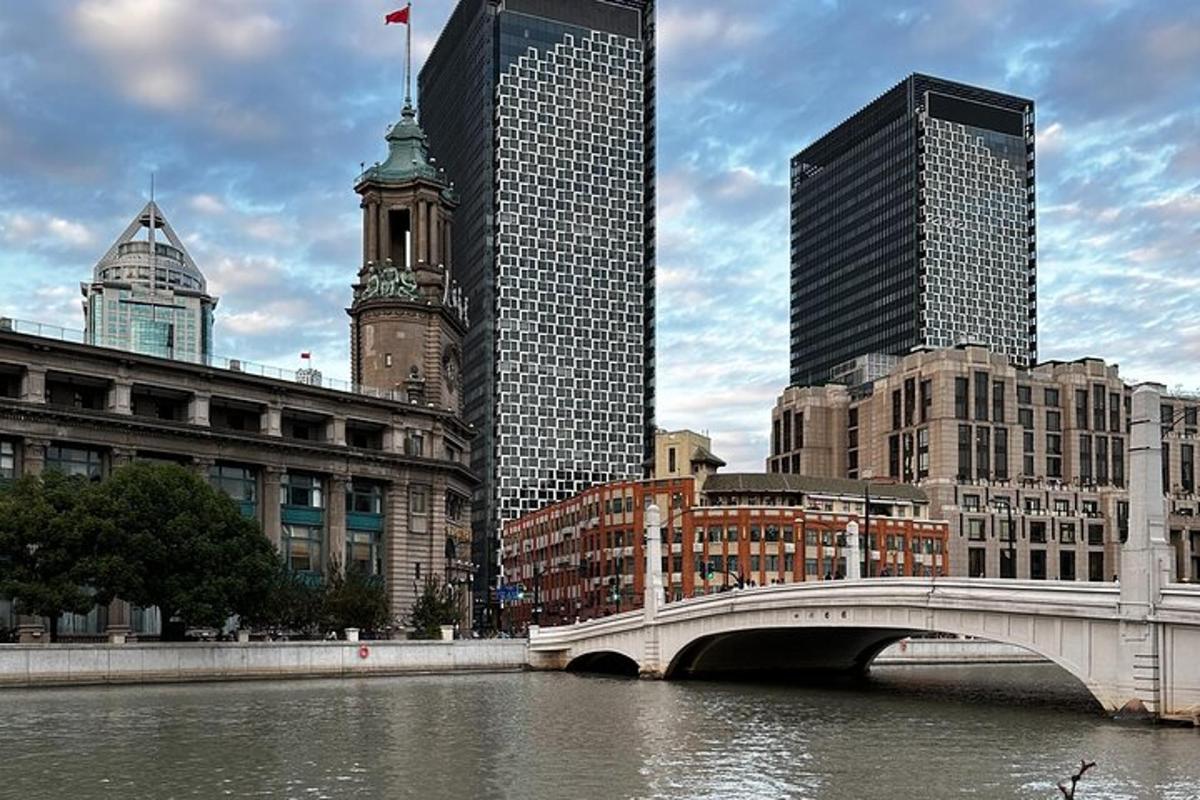 a bridge over a river in a city with tall buildings