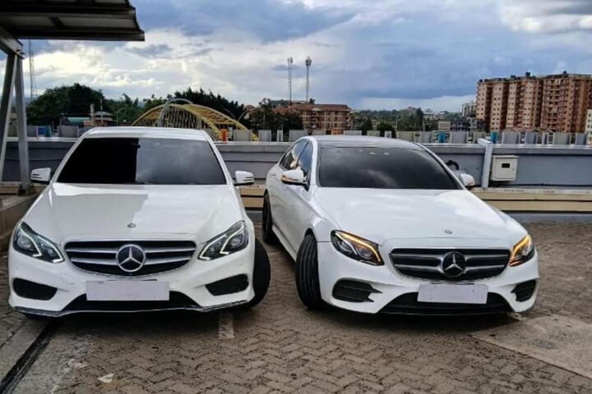 two white cars parked next to each other