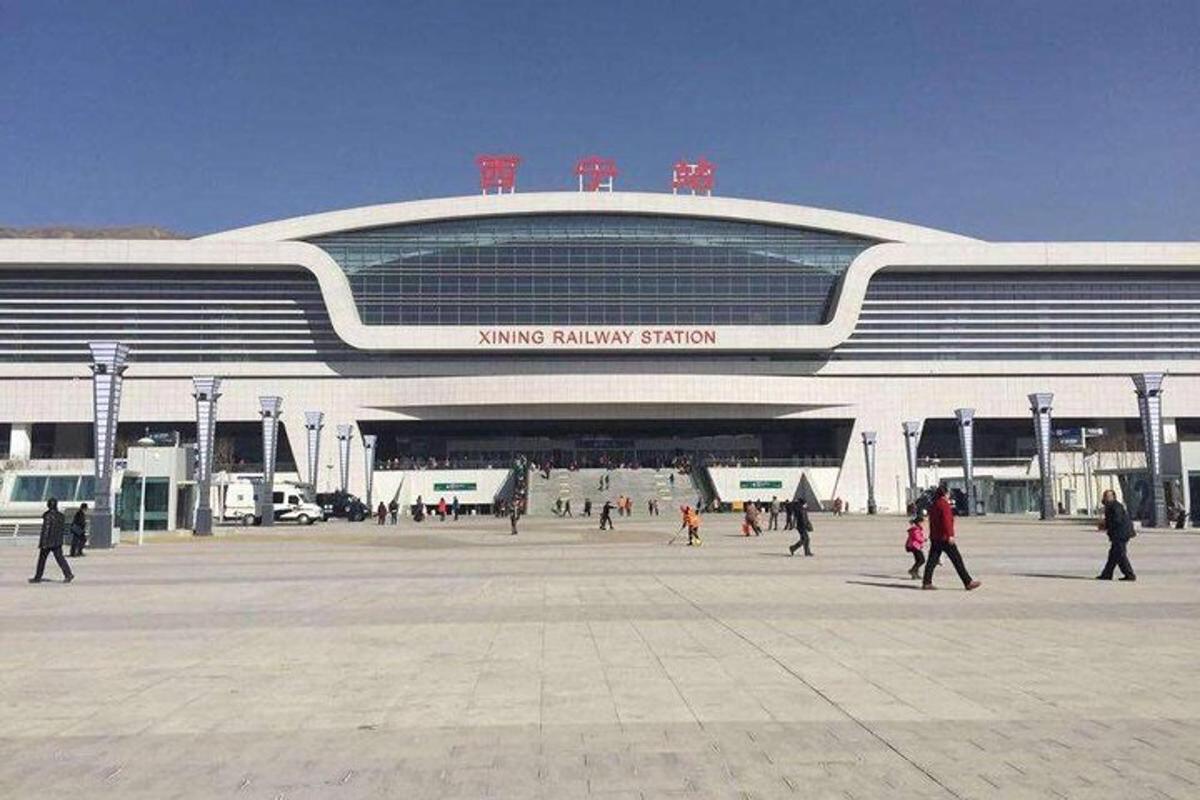 a large building with people walking in front of it
