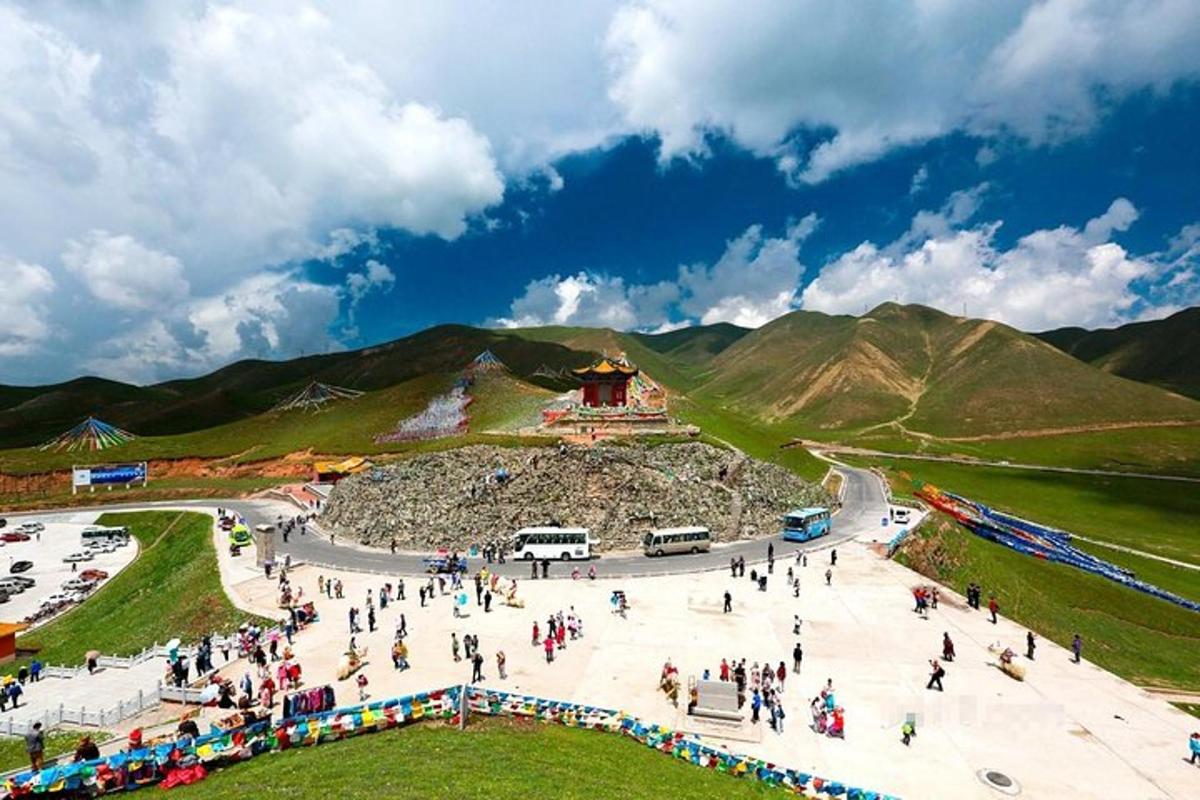 a group of people walking around a park in the mountains