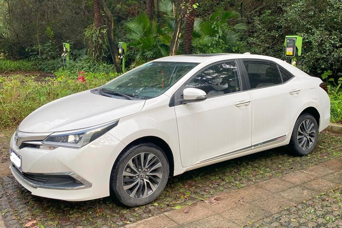 bílé auto zaparkované na příjezdové cestě