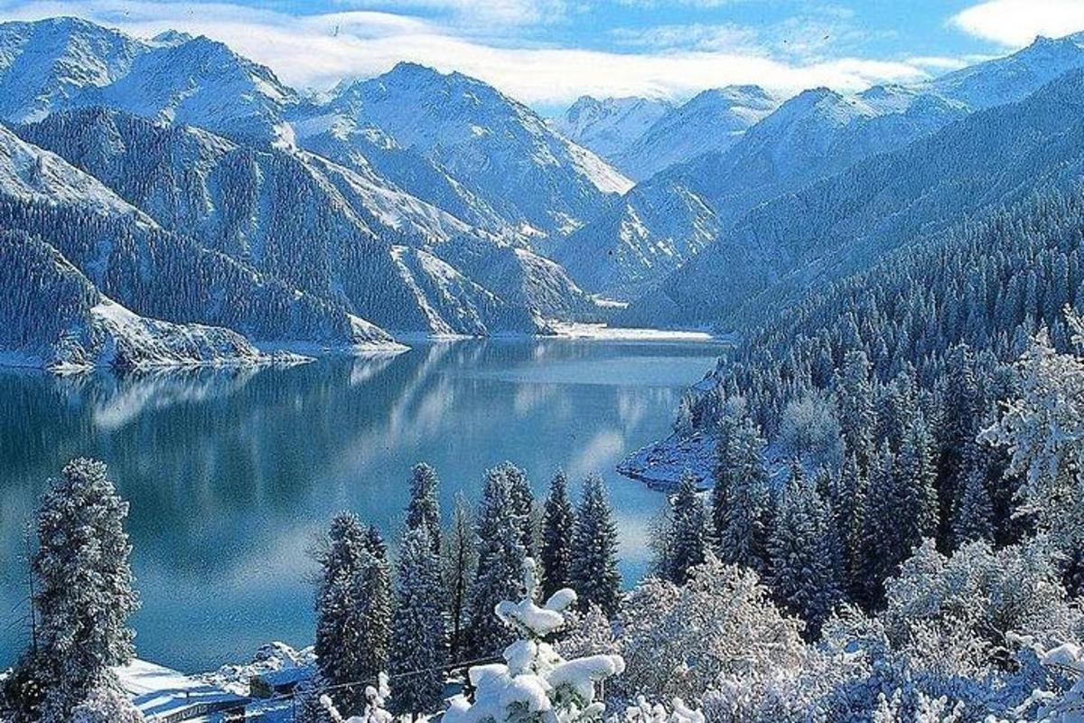a view of a lake with snow covered mountains