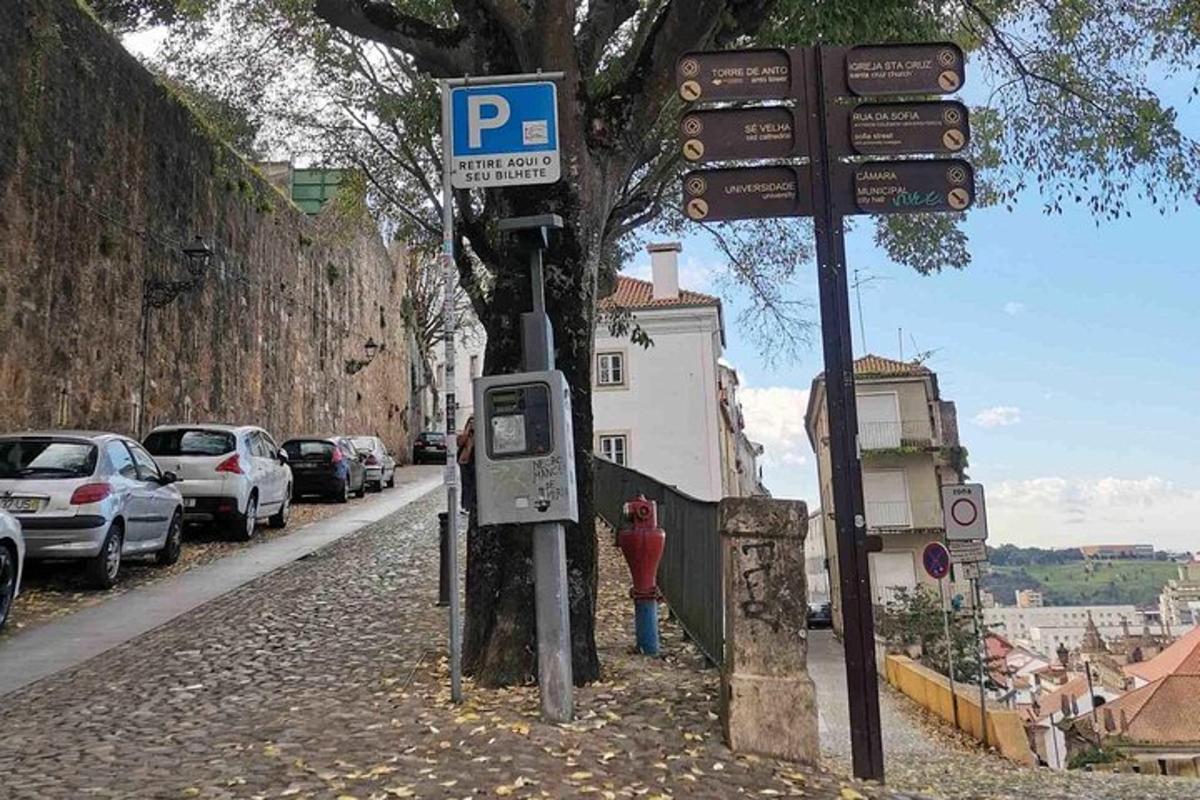 a street sign on the side of a street with cars