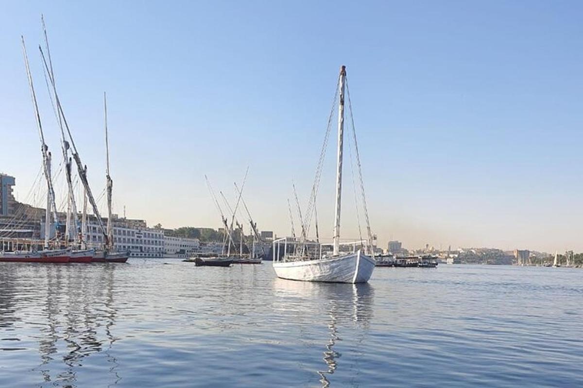 a white boat sitting in the water with other boats