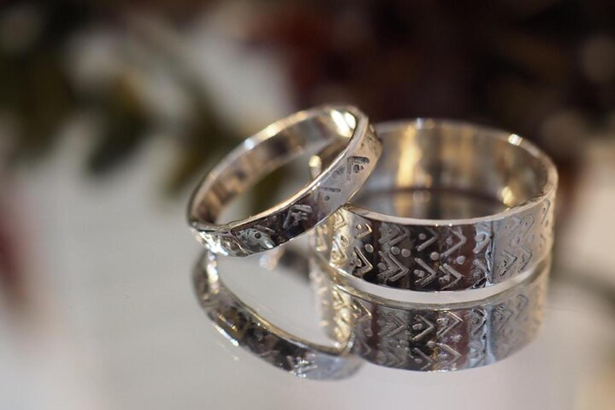 two silver rings sitting on top of a table