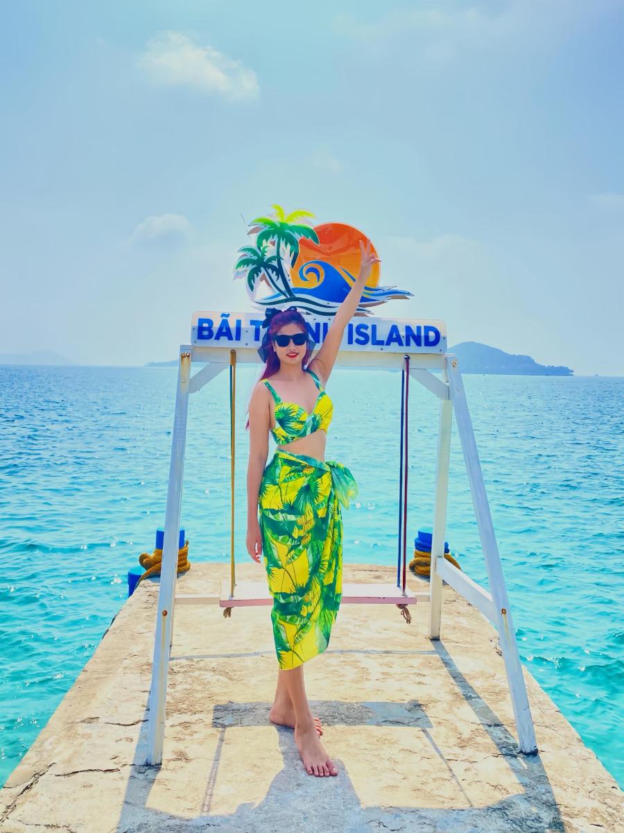 a woman standing on a dock in the water