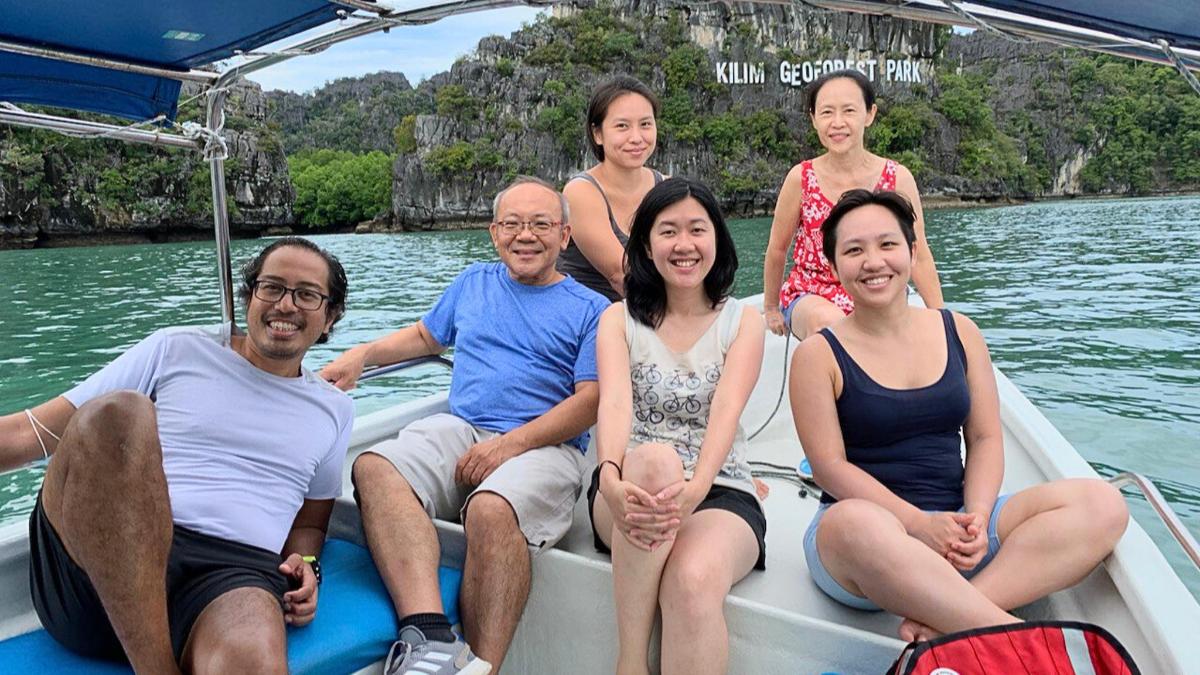 a group of people sitting on a boat in the water