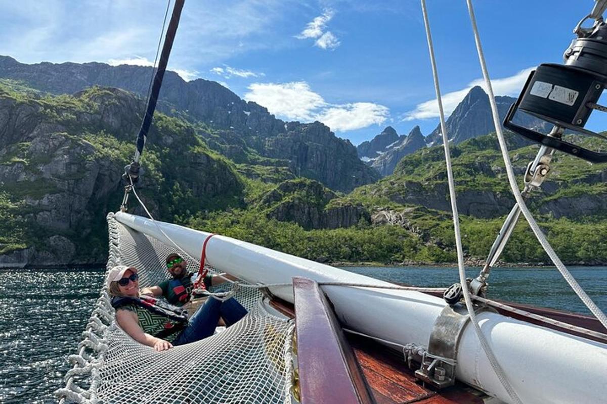 two people sitting on a boat in the water