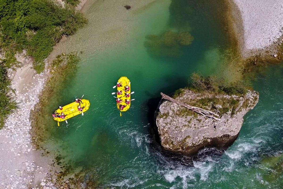 two boats in the water next to a rock