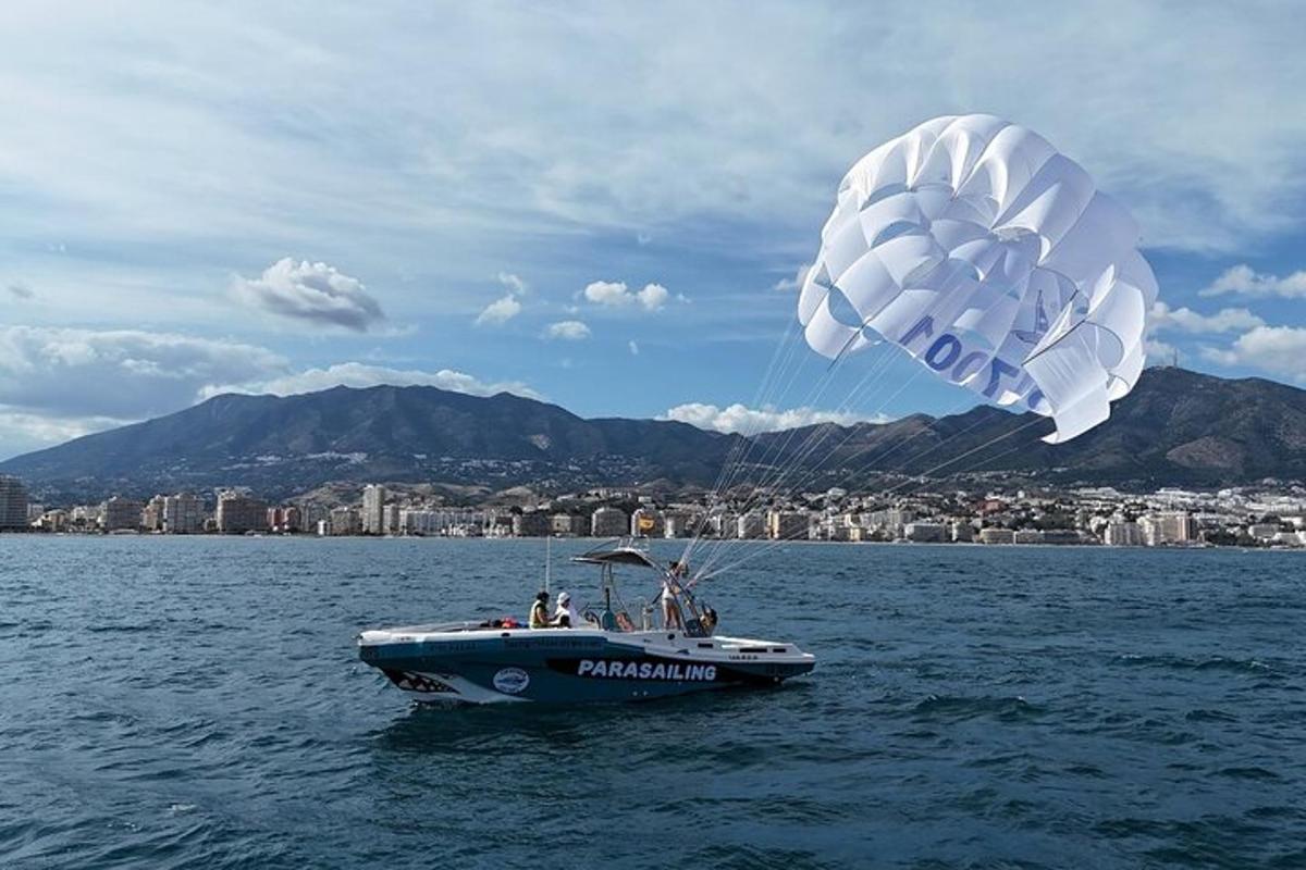 a boat in the water flying a kite