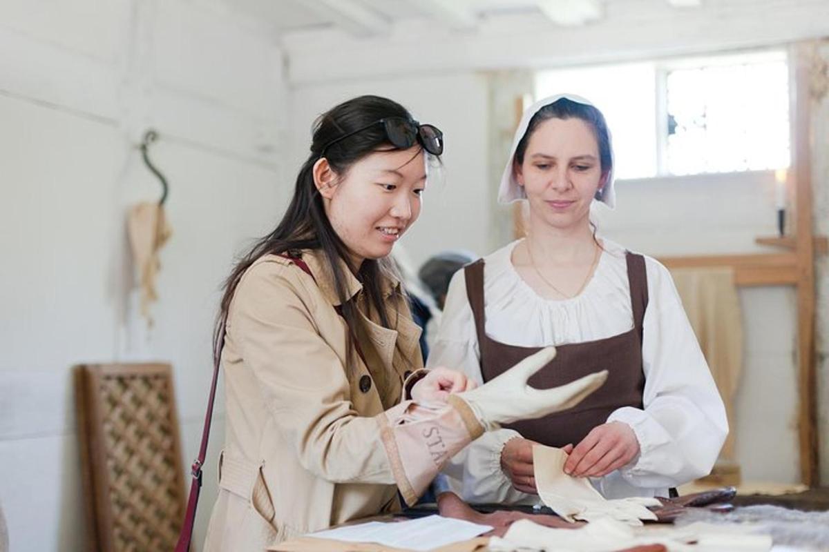 two women standing next to a table with papers
