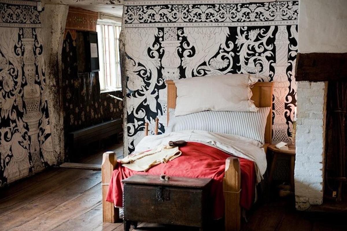 a bedroom with a bed with a black and white canopy
