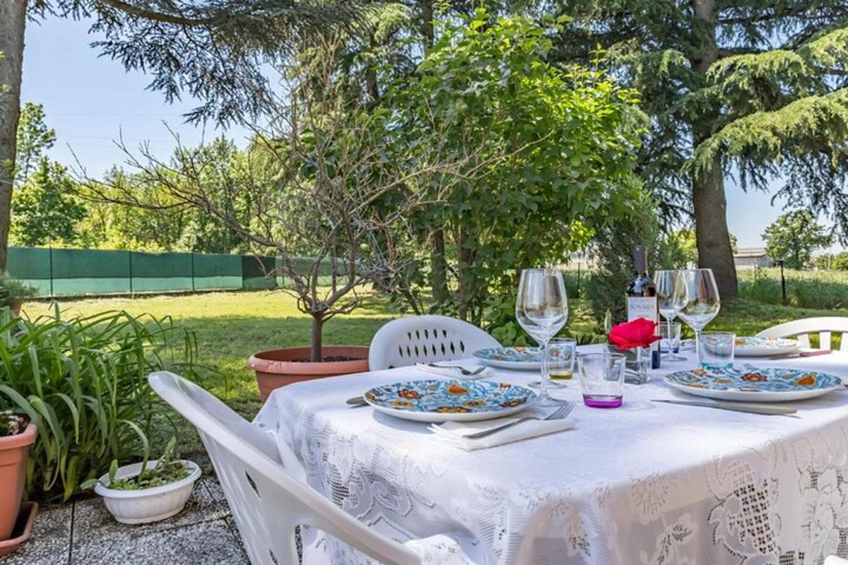 a white table with plates of food and wine glasses