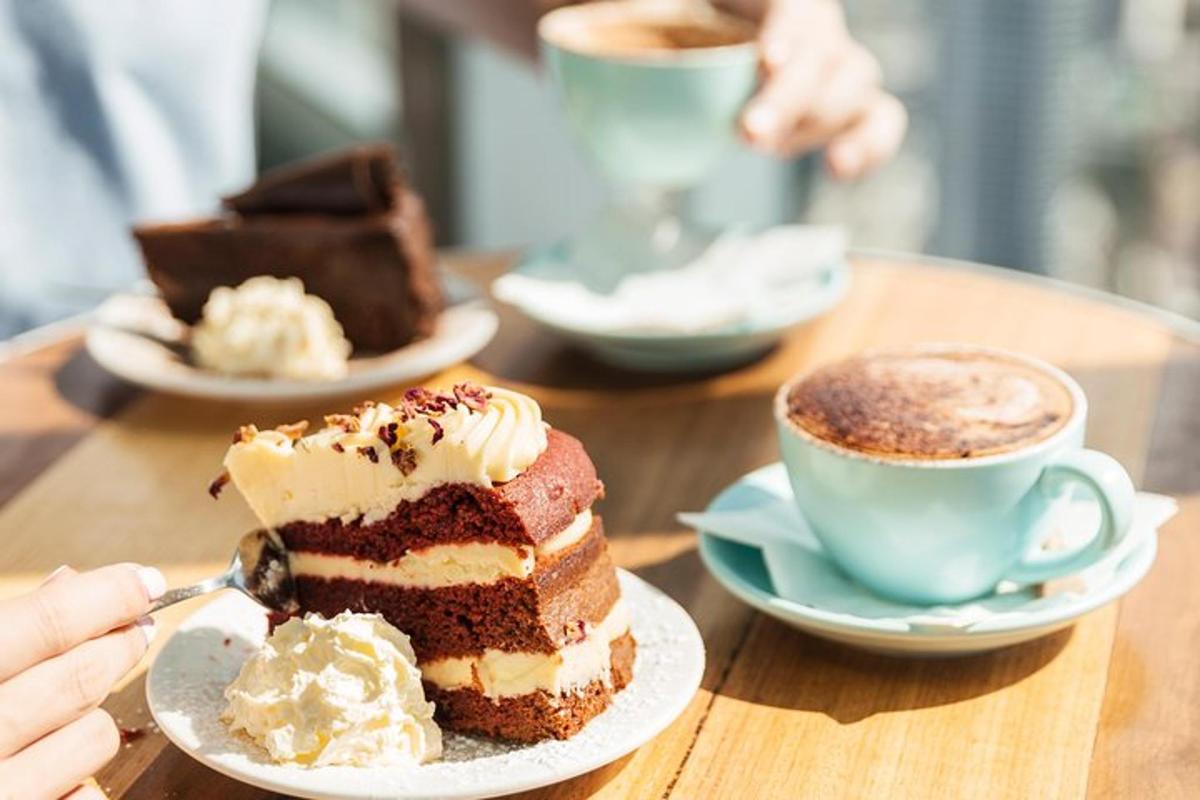 a table with a piece of cake and a cup of coffee