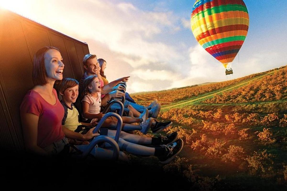 a group of people sitting on the side of a truck with a balloon