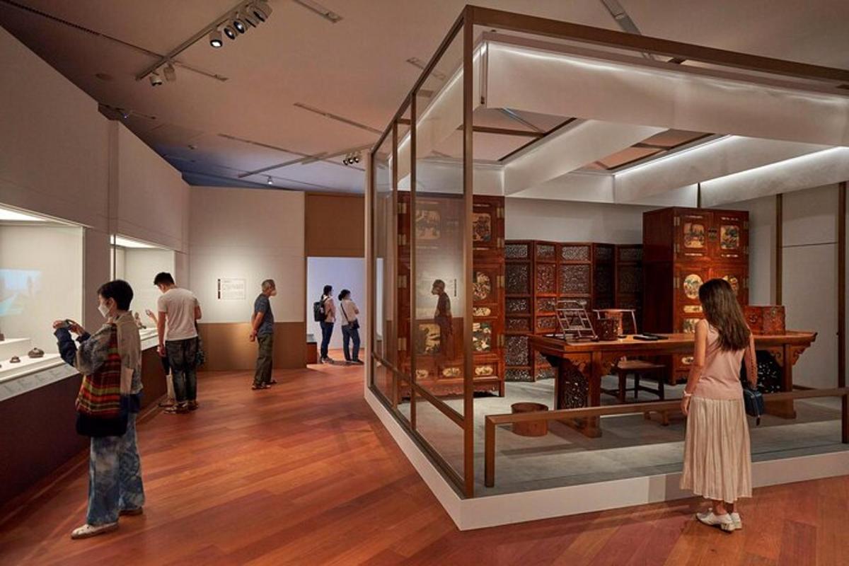 a group of people looking at a museum exhibit