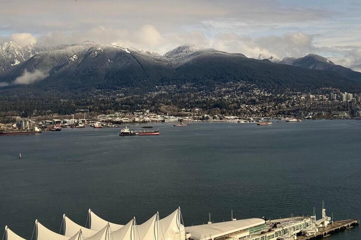 a large body of water with a city and mountains