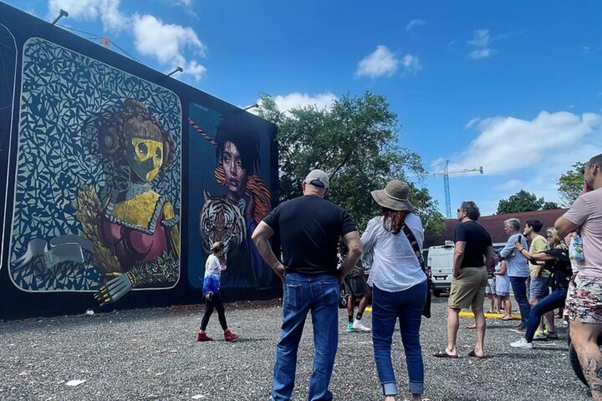 a group of people standing in front of a mural