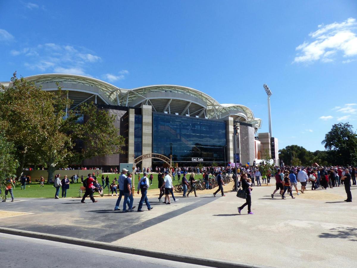 a crowd of people walking in front of a building