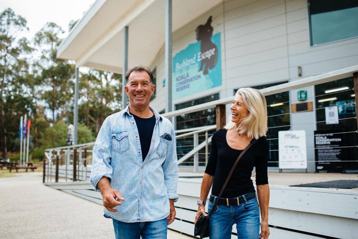 a man and a woman standing outside of a building