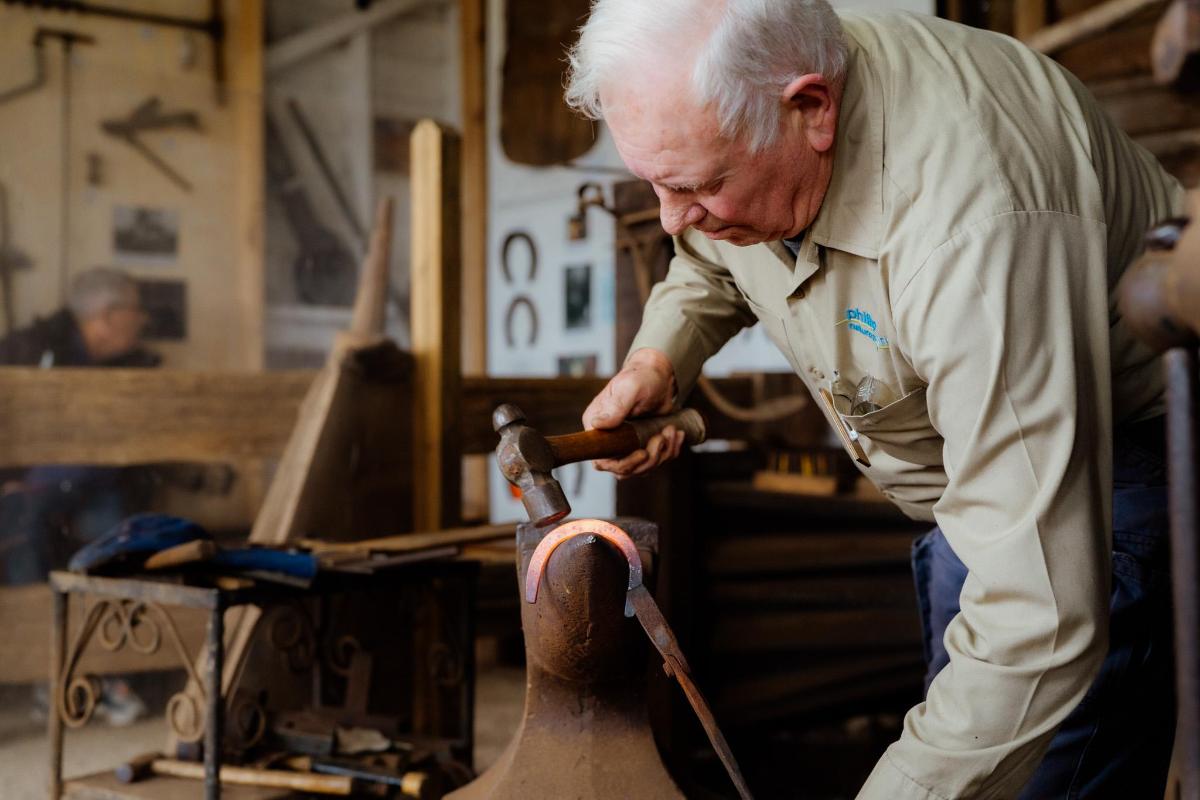 a man working on a vase in a shop