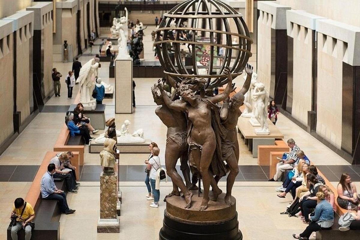 a statue in a building with a crowd of people