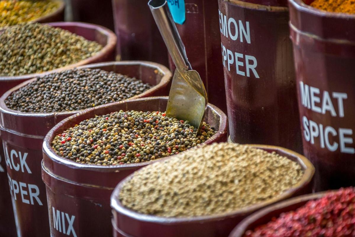 a group of containers filled with different types of spices