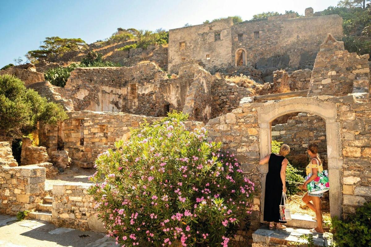 two people standing in an archway with a castle in the background