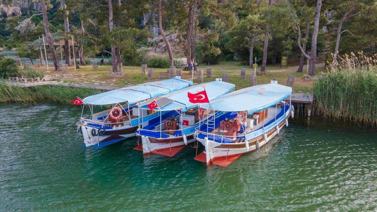 two boats are docked in the water with flags on them