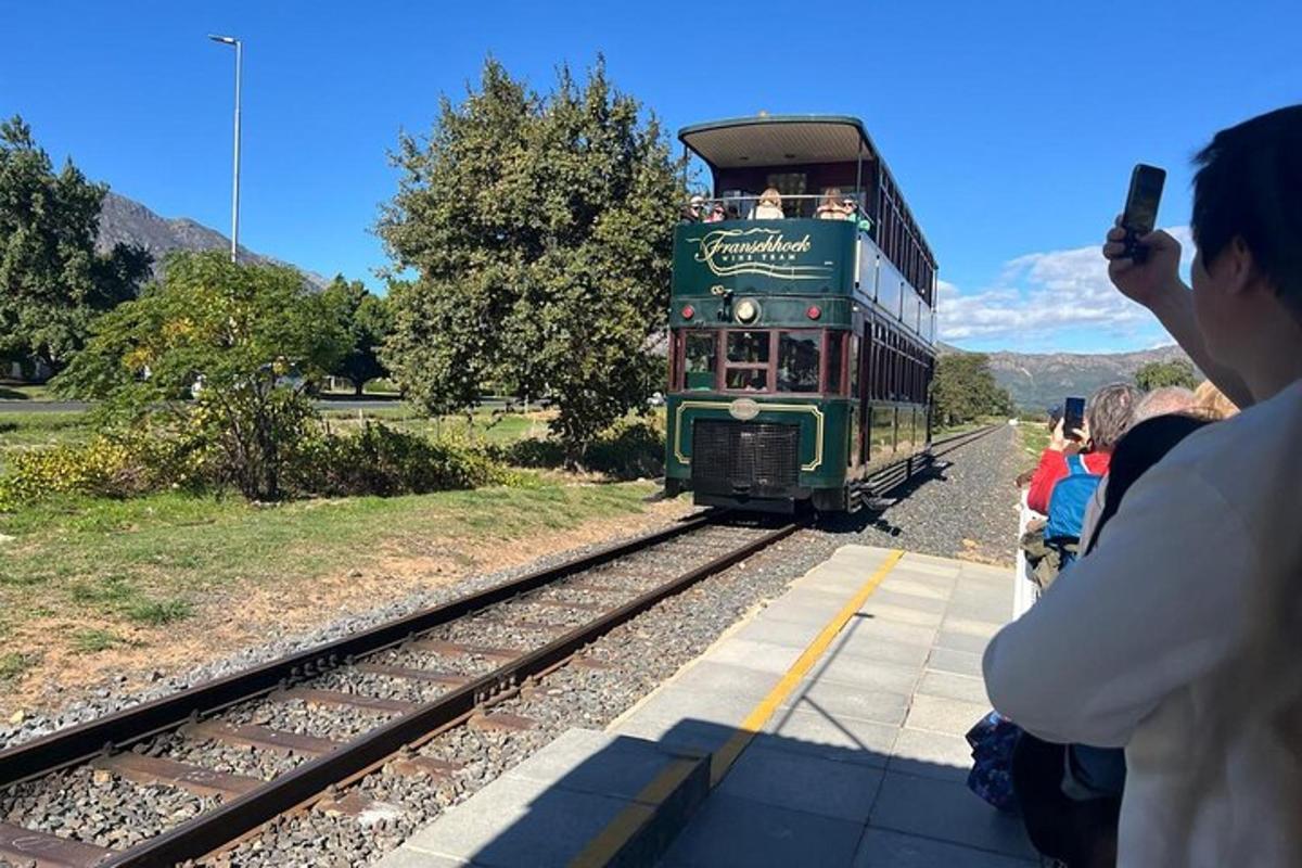 a person taking a picture of a green train