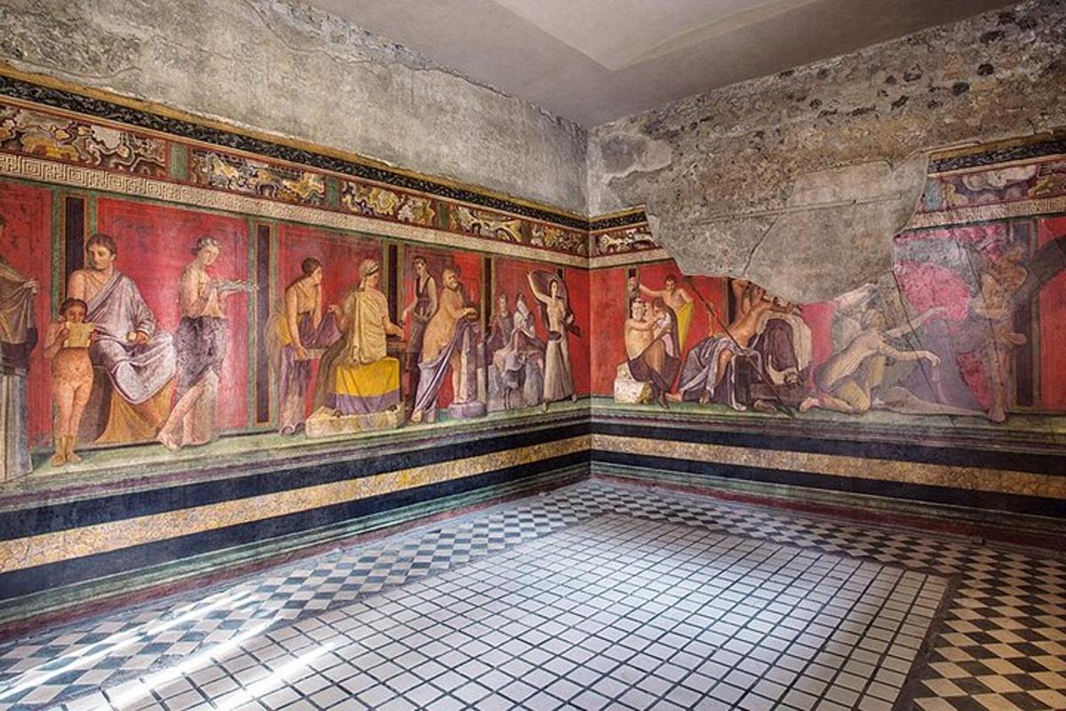 a room with paintings on the walls of a building