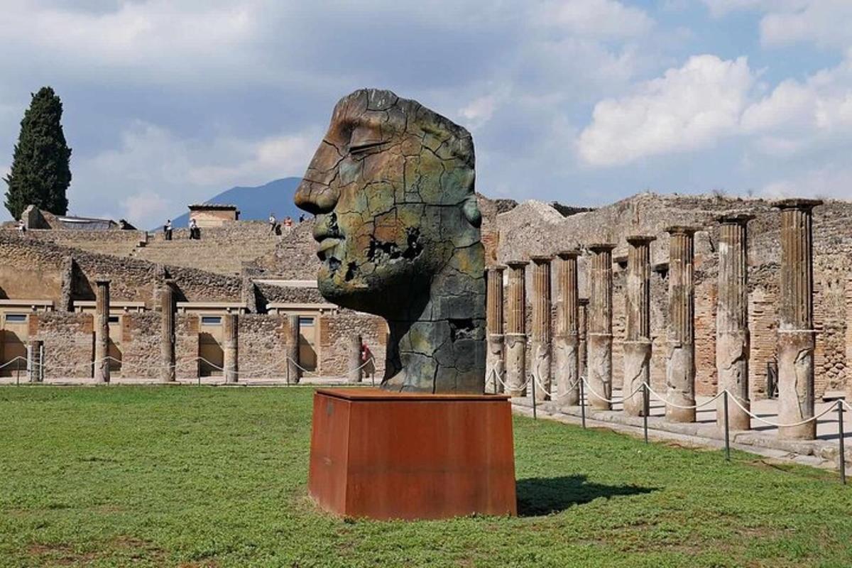a statue of a head in front of a building