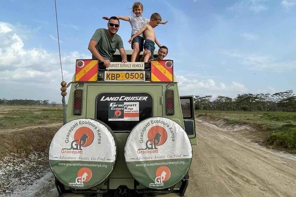 a group of people sitting on the back of a vehicle