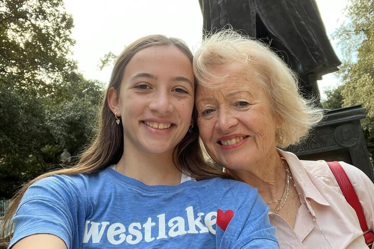 a woman hugging a girl in a blue shirt