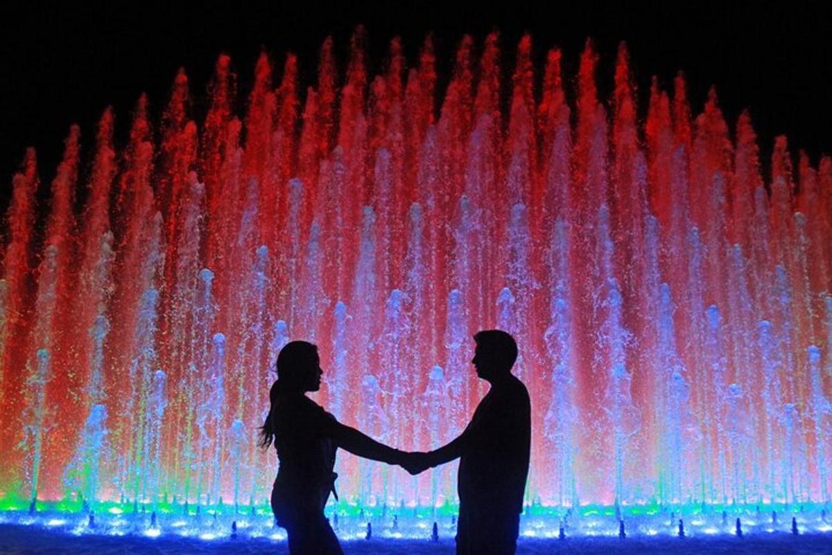 un uomo e una donna in piedi davanti a una fontana