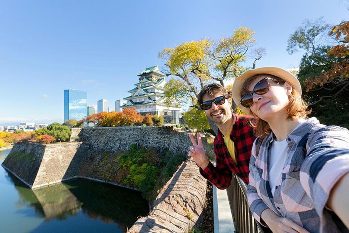 a man and a woman standing on a stone wall