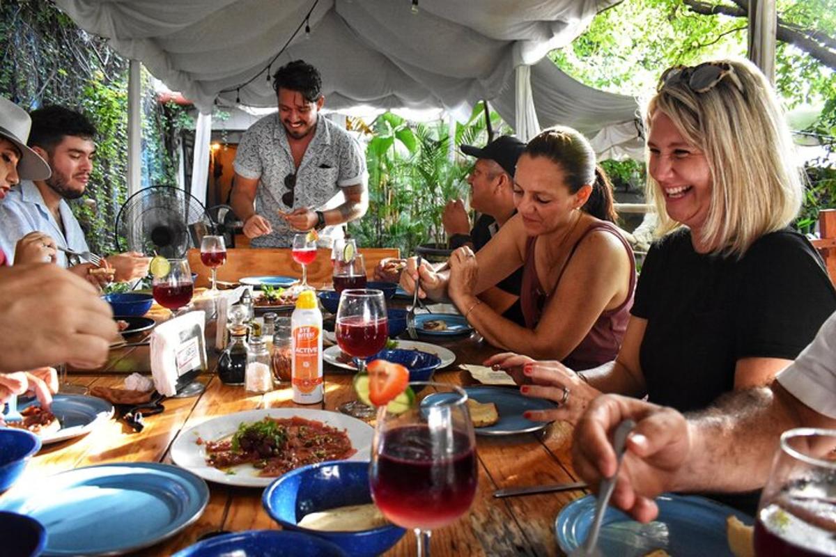a group of people sitting around a table eating food