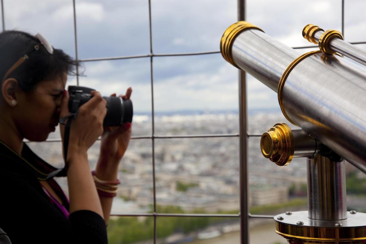 a woman taking a picture of a city with a camera