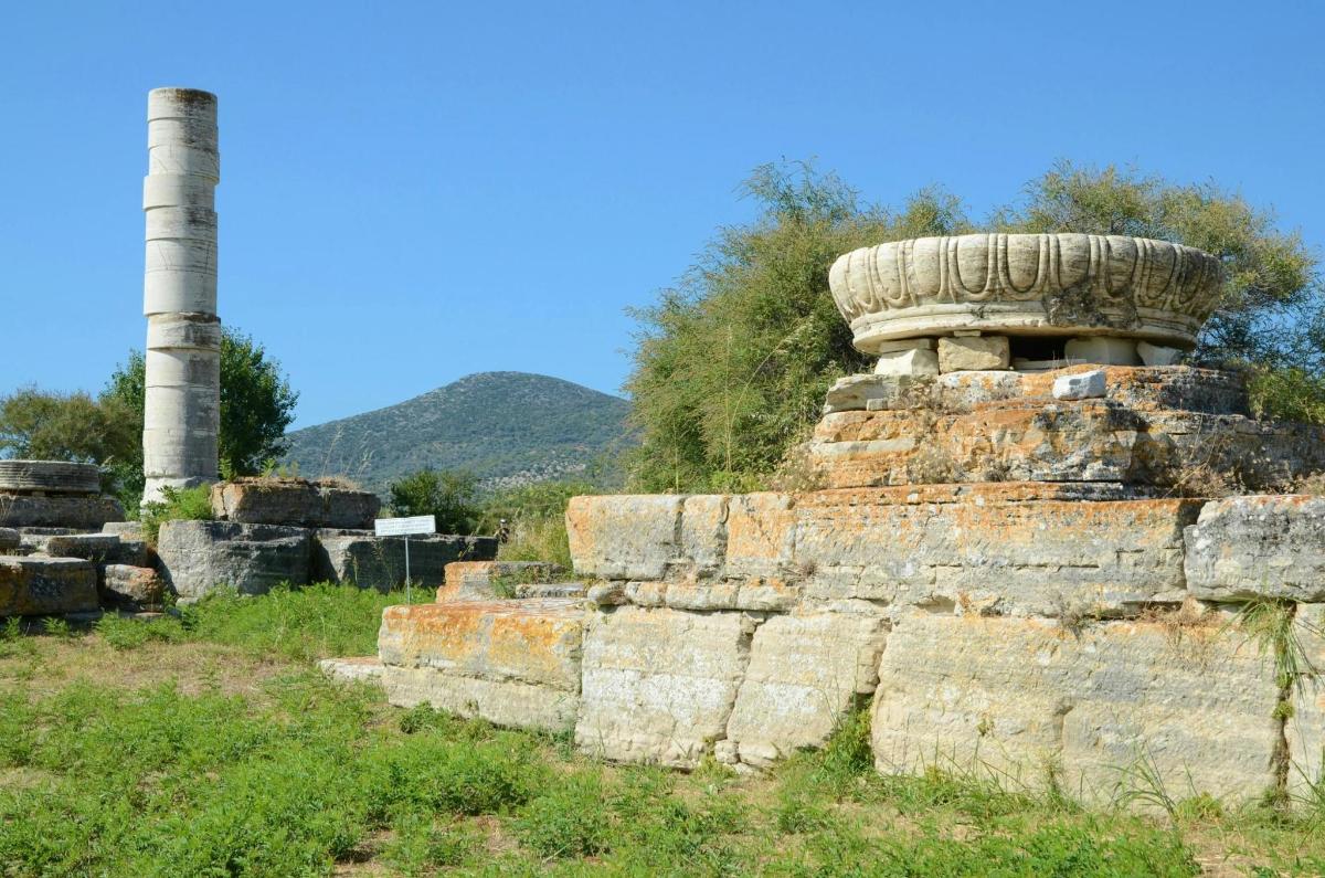 a stack of ruins with a pole in the background