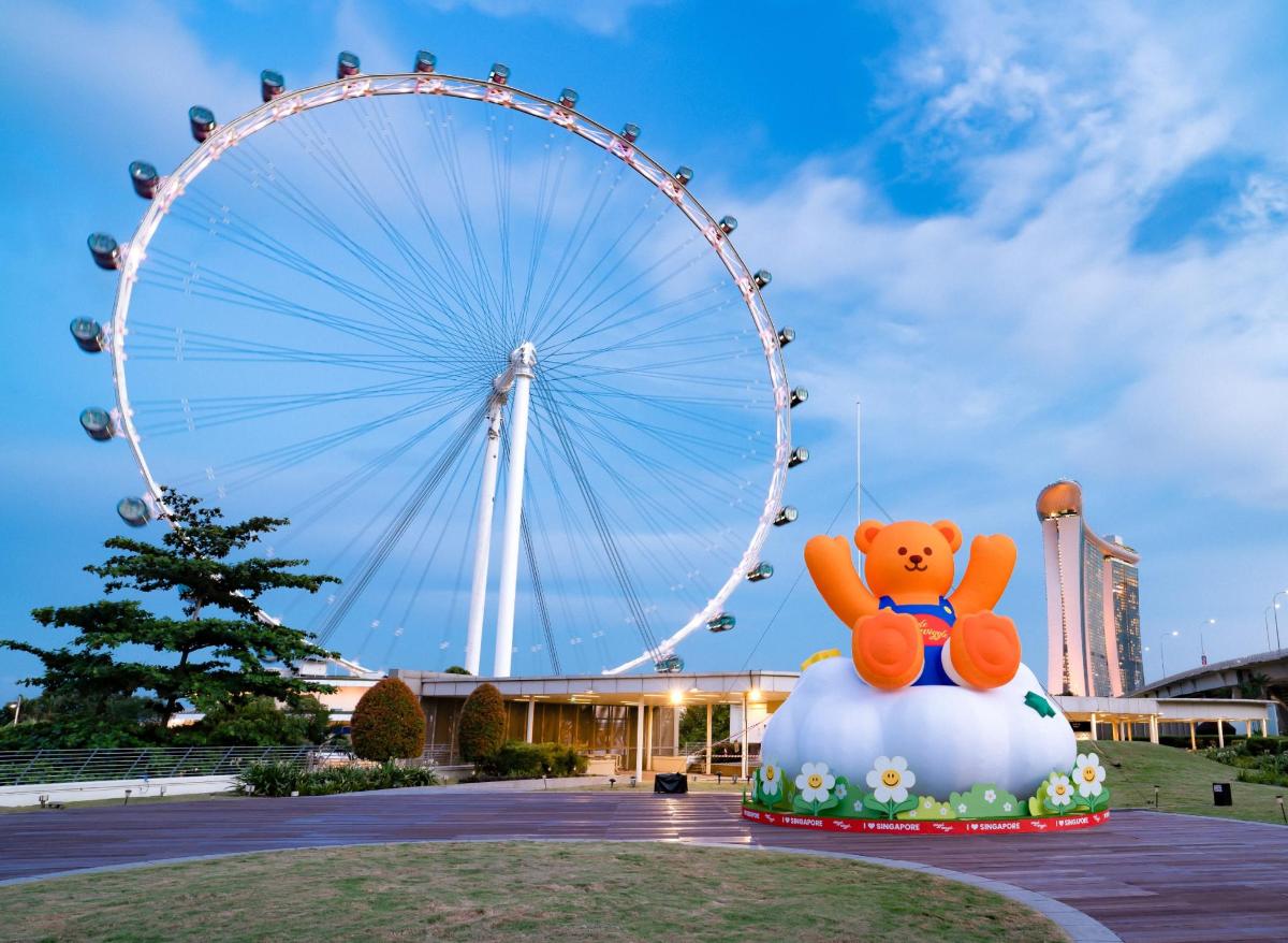 a large ferris wheel with a teddy bear on top
