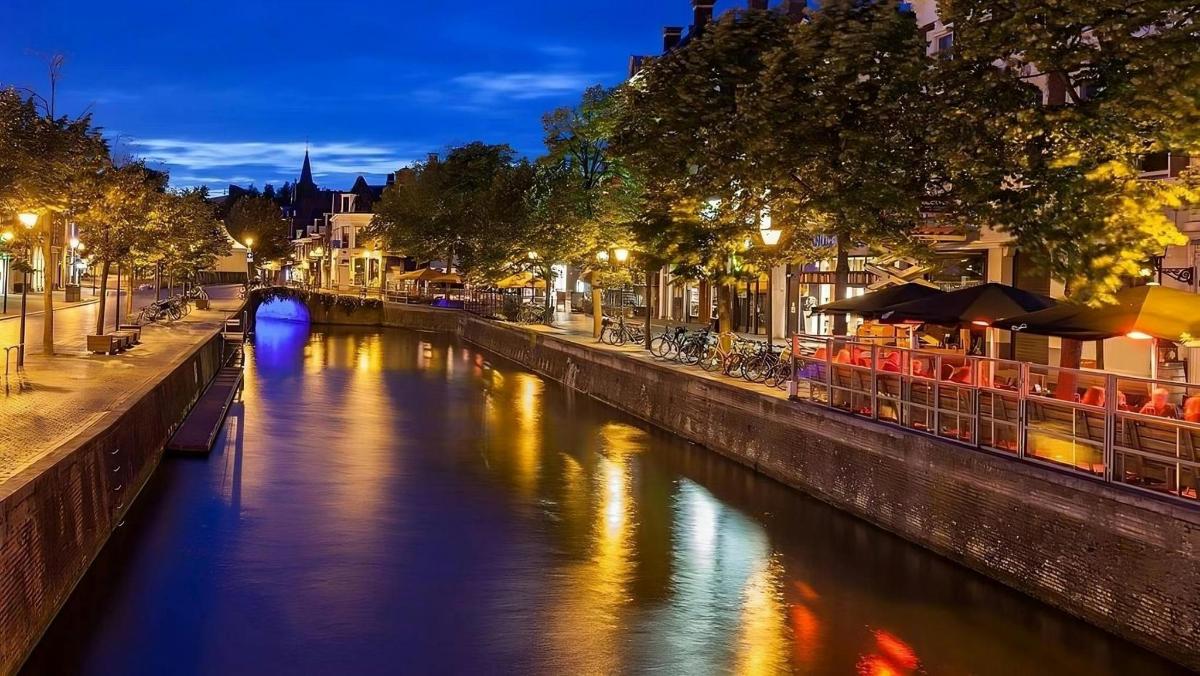 a river in a city at night with lights on