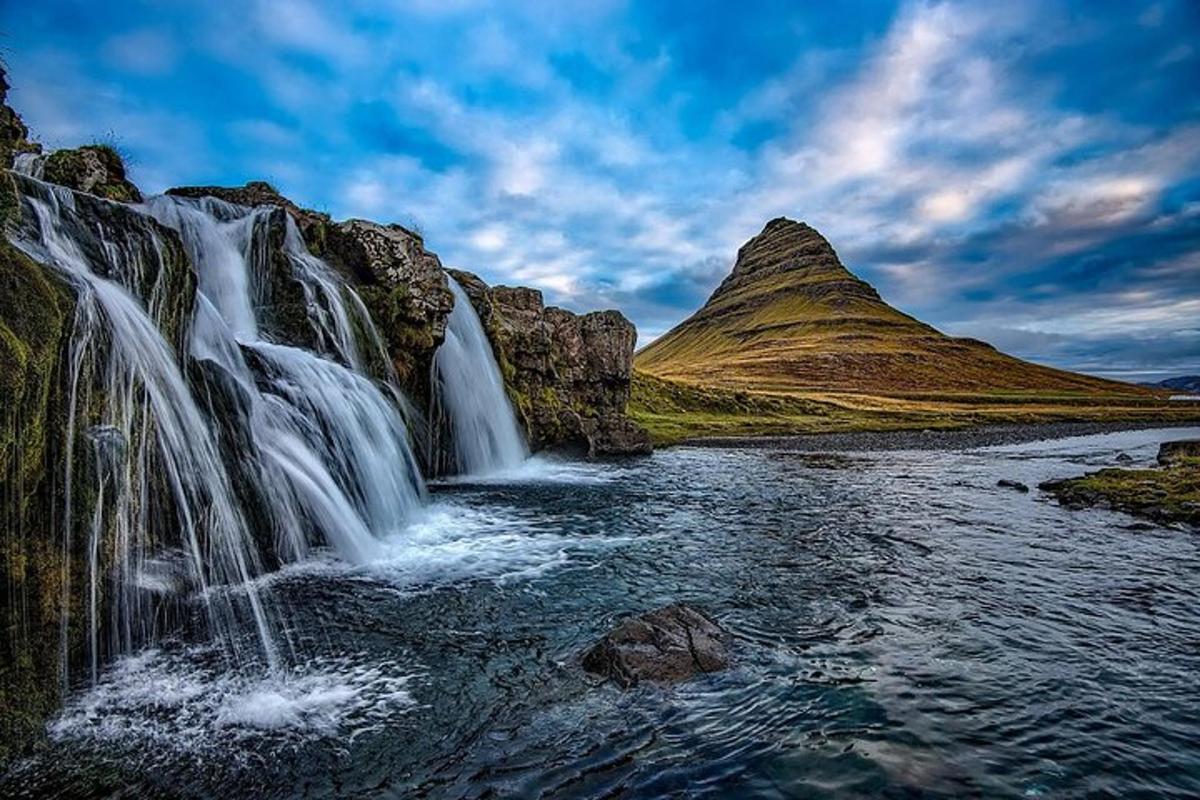 a waterfall in the middle of a mountain