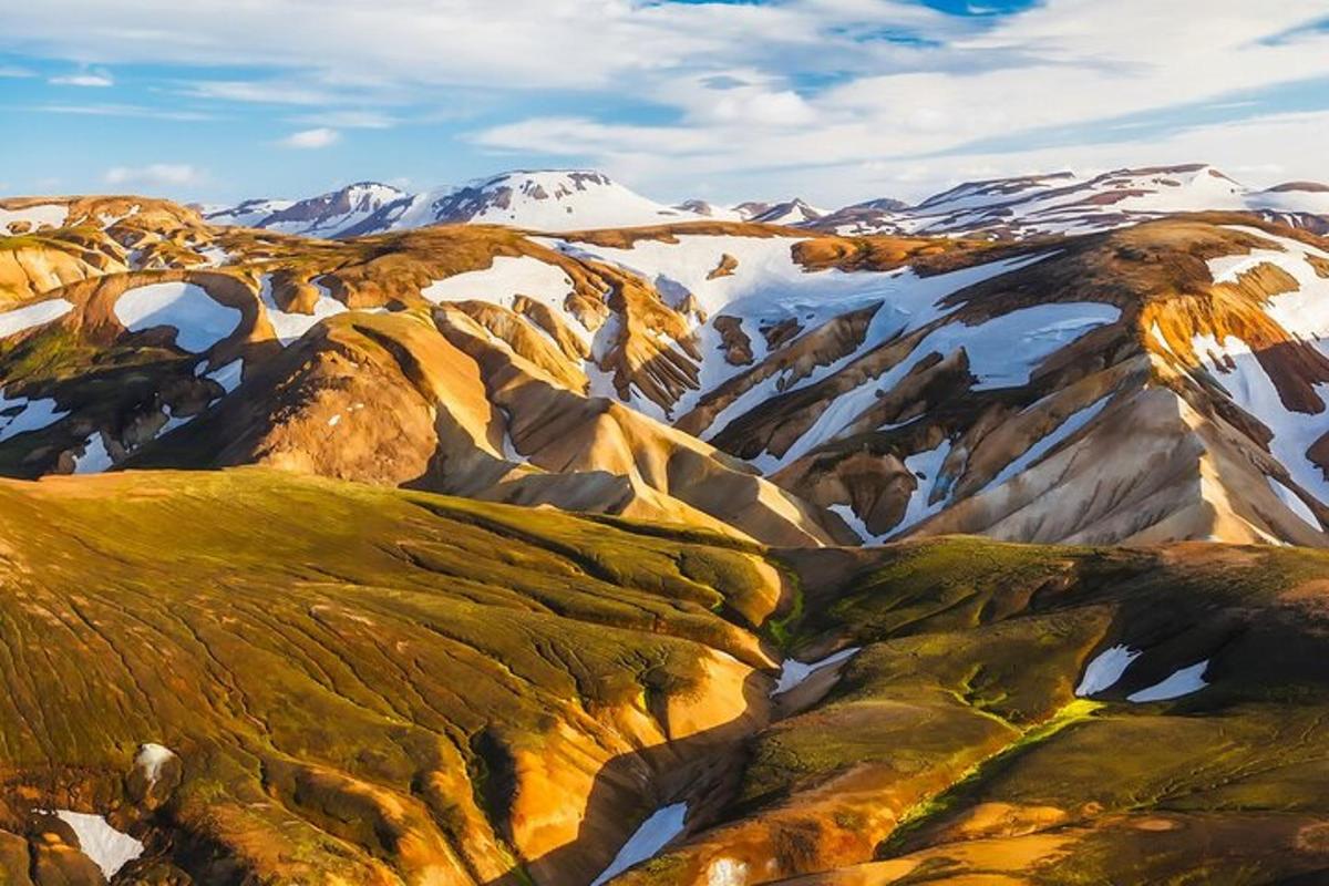an aerial view of a snowy mountain range