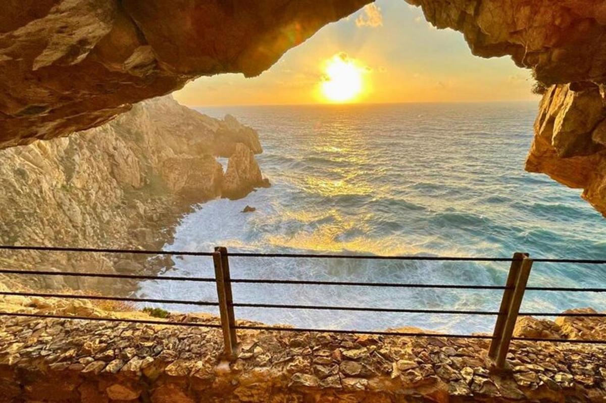 a view of the ocean from a rock cave