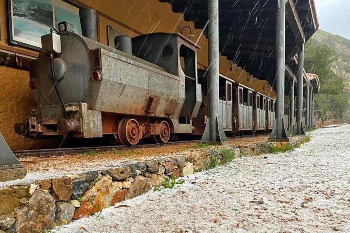 a train sitting on the tracks at a train station