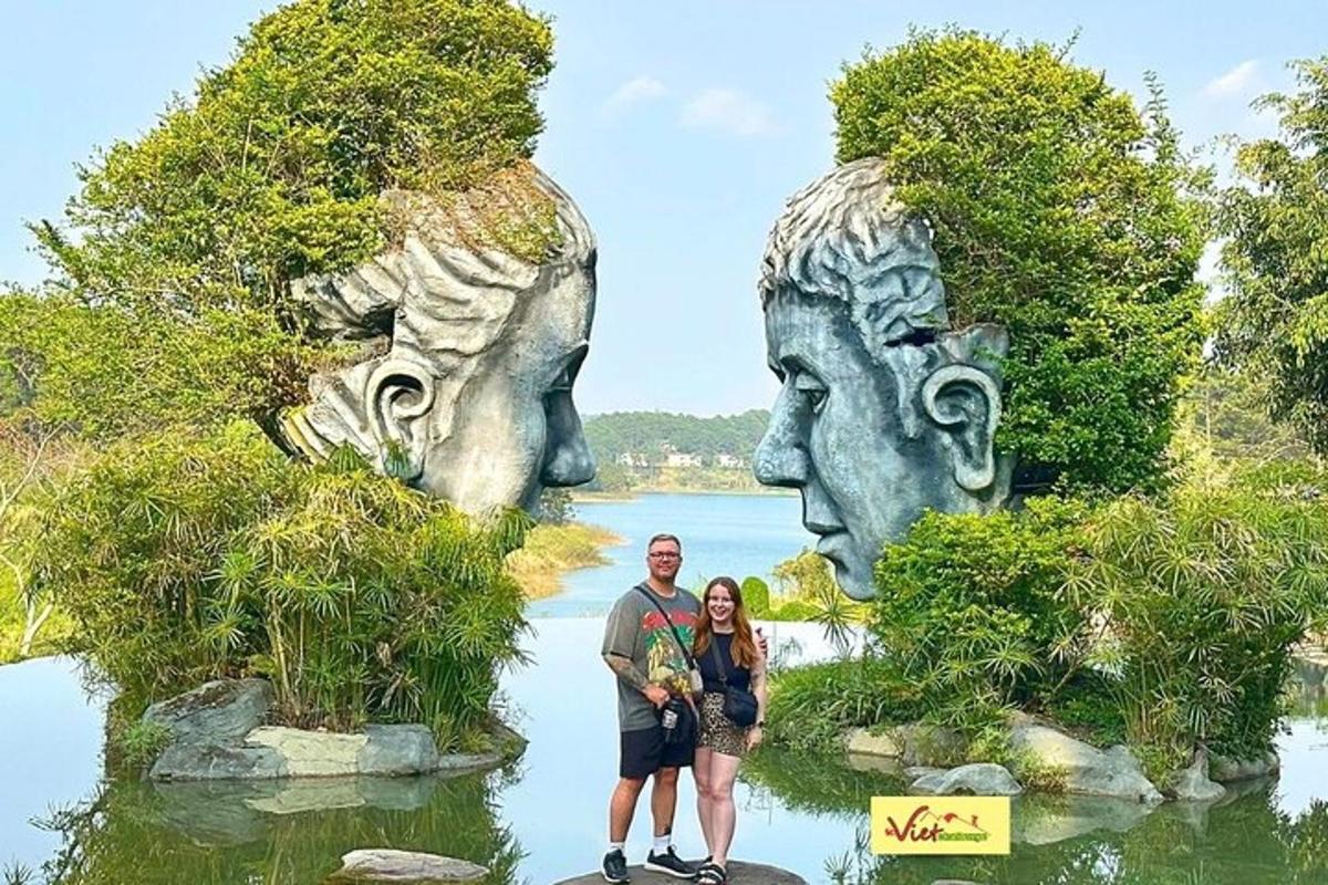 a man and a woman standing in front of a statue